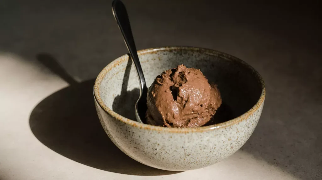 Freshly blended chocolate nice cream banana resting in bowl