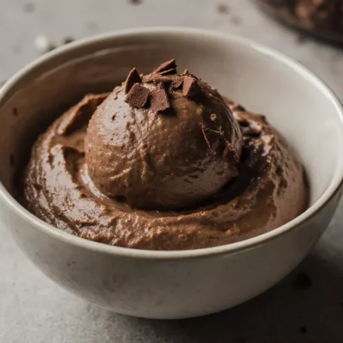 Chocolate nice cream banana served in a simple bowl with creamy texture