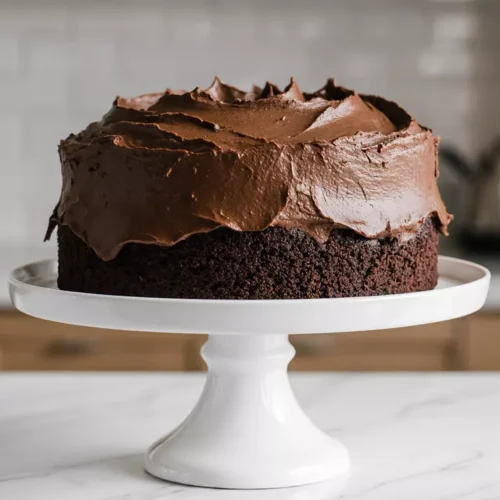 Frosted Skor bar chocolate cake resting on kitchen counter