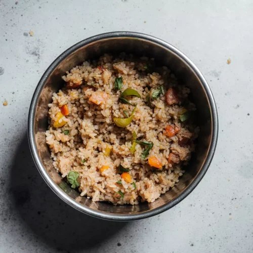Homemade thermomix dog food served in a bowl with rice, turkey, and vegetables