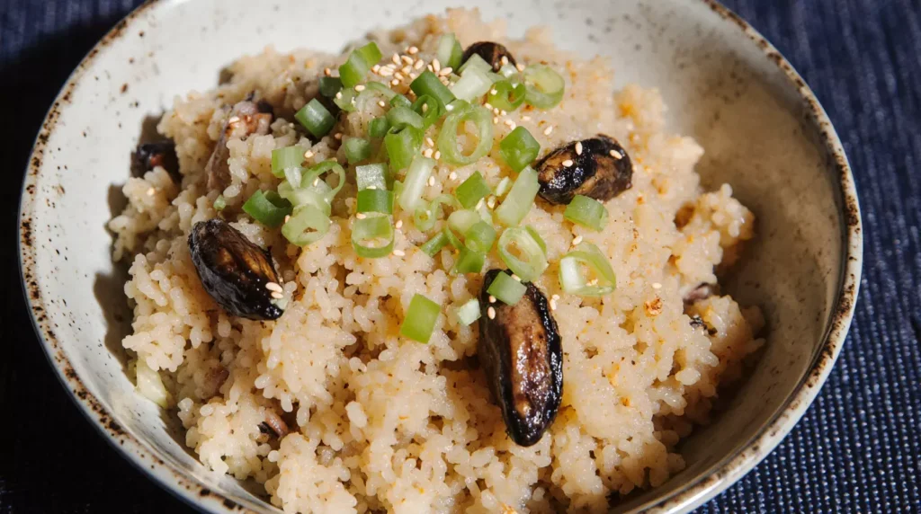 Smoked oysters served over seasoned rice with green onions