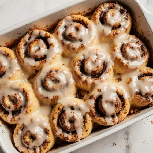 Top view of espresso cinnamon rolls arranged evenly in a baking dish